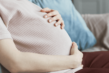 Pregnant-woman-sitting-on-sofa-1421240